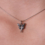 Silver butterfly pendant necklace on a person's neck