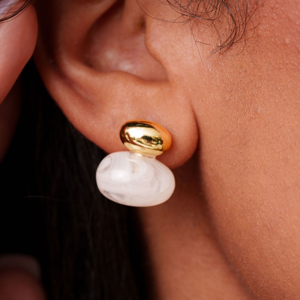 Sintra Studs in Blanco, gold dome stud with white marbled resin drop, close-up
