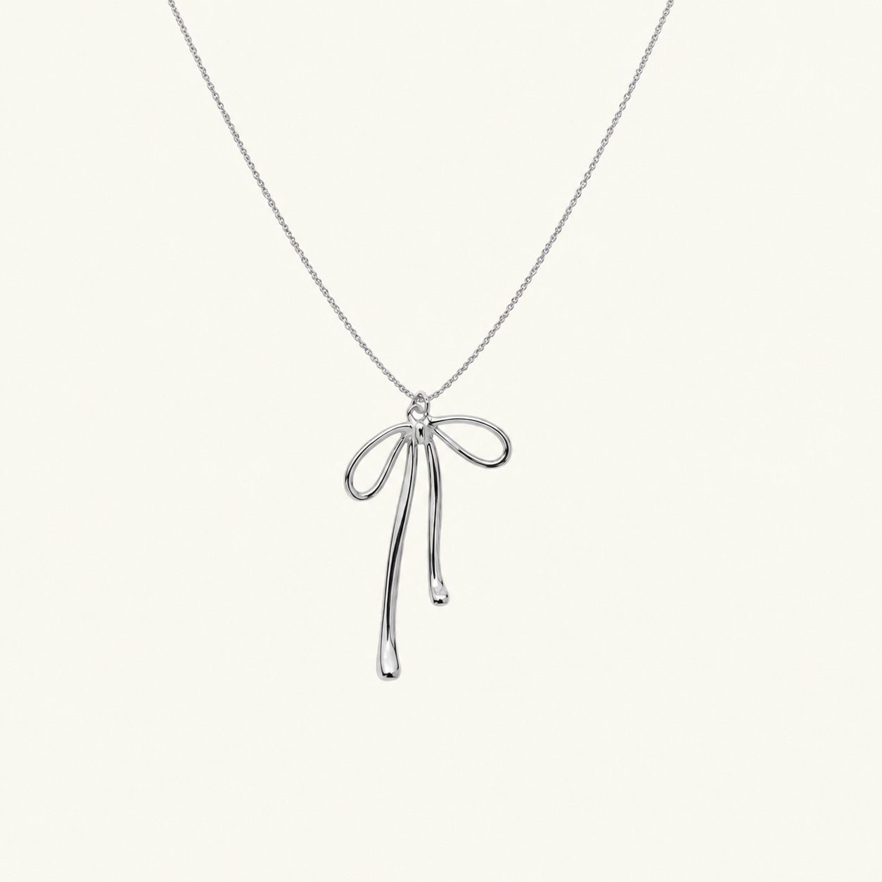 Silver bow pendant necklace by Tikkhu