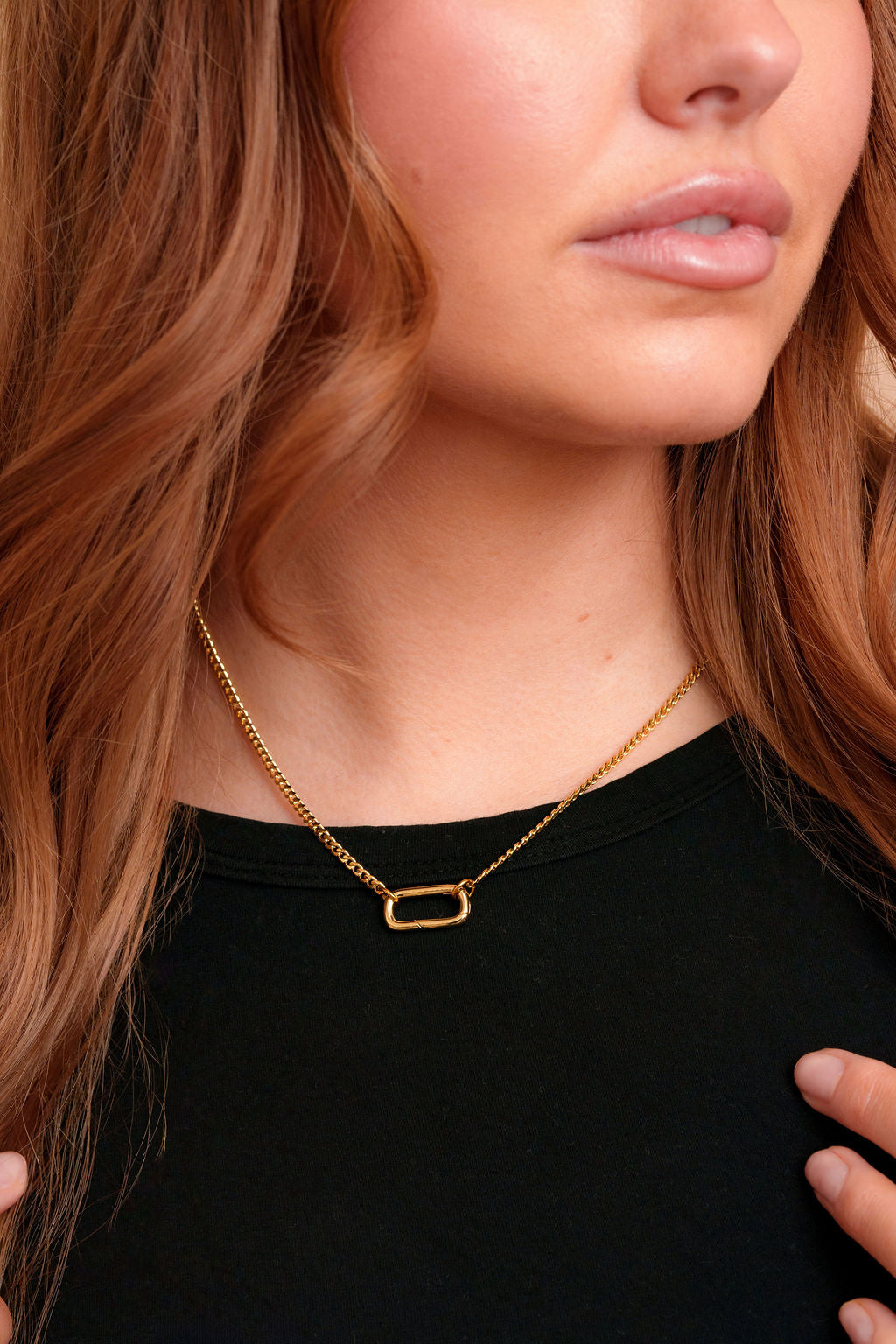 Model wearing the Vada Mini gold filled carabiner necklace by Tikkhu