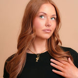 Vada Mini Carabiner Necklace on a model with charms. Charms sold separately